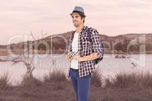 Composite image of happy man holding camera