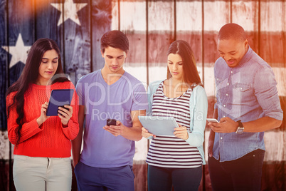 Composite image of young creative team looking at phones and tab