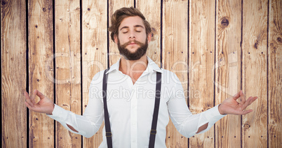 Composite image of hipster meditating arms outstretched