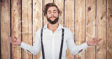 Composite image of hipster meditating arms outstretched