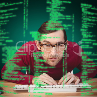 Composite image of portrait of concentrated man working on compu