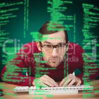 Composite image of portrait of concentrated man working on compu