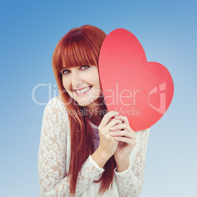 Composite image of smiling hipster woman with a big red heart