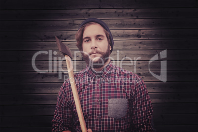 Composite image of portrait of hipster holding axe