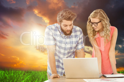 Composite image of man using laptop while discussing with woman