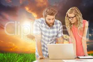 Composite image of man using laptop while discussing with woman