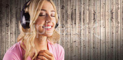 Composite image of close up of a woman listening to music