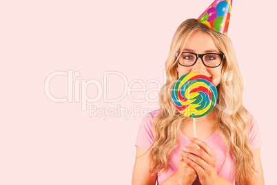 Composite image of a beautiful hipster holding a giant lollipop