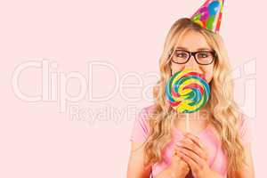 Composite image of a beautiful hipster holding a giant lollipop