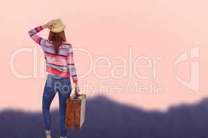 Composite image of rear view of a hipster woman holding suitcase