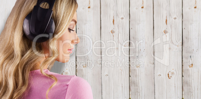 Composite image of close up of a woman listening to music