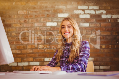 Composite image of pretty casual worker at her desk