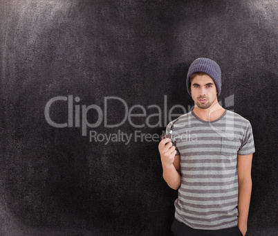 Composite image of portrait of man holding smoking pipe