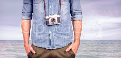 Composite image of hipster man holding digital camera