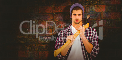 Composite image of portrait of confident man holding axe on shou