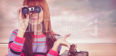 Composite image of smiling hipster woman looking through binocul