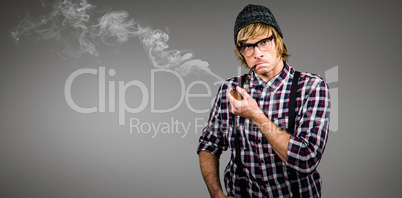 Composite image of serious blond hipster smoking a pipe