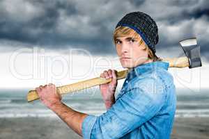 Composite image of profile of hipster standing with axe