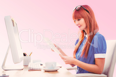 Composite image of smiling hipster woman looking at document