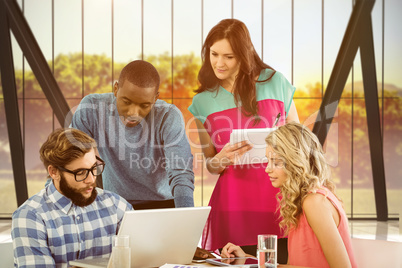 Composite image of man discussing with coworkers at desk