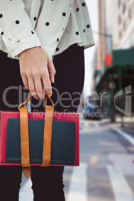 Composite image of cropped image of woman holding book belt