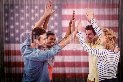Composite image of happy creative team giving high fives to each