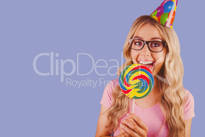 Composite image of a beautiful hipster holding a giant lollipop