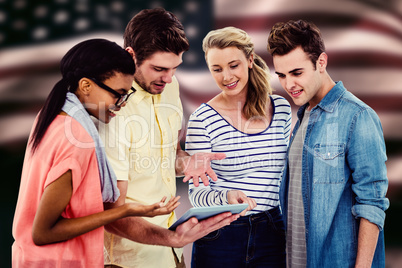 Composite image of happy creative team using a tablet pc