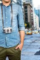 Composite image of hipster man holding digital camera