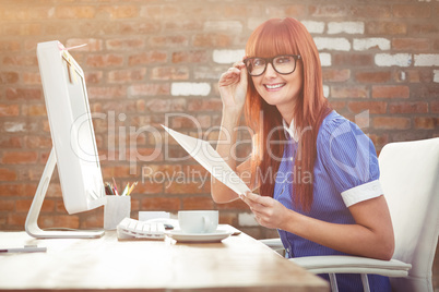 Composite image of smiling hipster woman with document