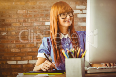 Composite image of attractive hipster woman using graphics table