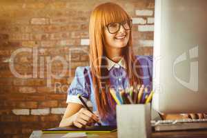 Composite image of attractive hipster woman using graphics table
