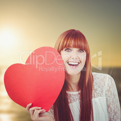 Composite image of smiling hipster woman with a big red heart