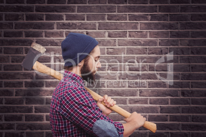 Composite image of side view of hipster with axe