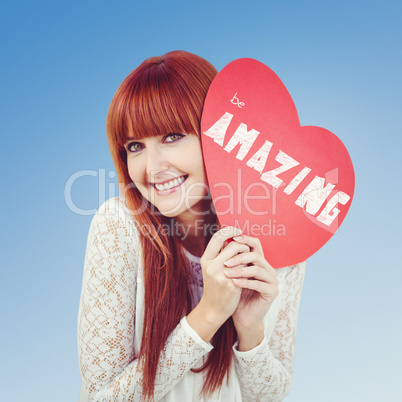 Composite image of smiling hipster woman with a big red heart