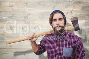 Composite image of hipster holding axe on shoulder