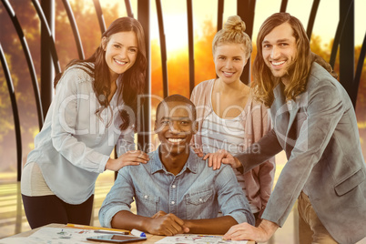 Composite image of portrait of smiling business team putting han