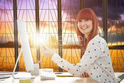 Composite image of smiling hipster woman pointing screen with pe