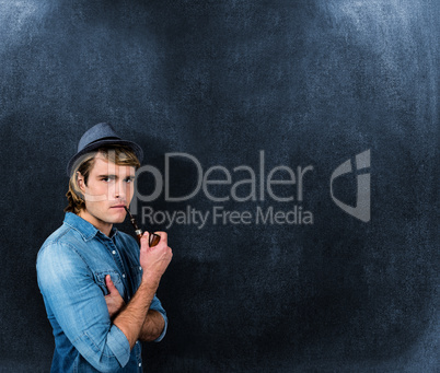 Composite image of serious hipster smoking pipe