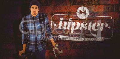 Composite image of portrait of hipster standing with bicycle