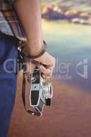 Composite image of cropped image of man holding camera