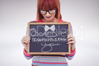 Woman holding small blackboard