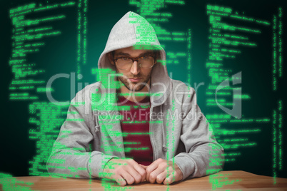 Composite image of thoughtful man with hooded shirt sitting at d