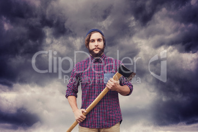 Composite image of portrait of hipster with axe