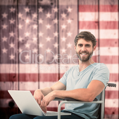 Composite image of young businessman using laptop