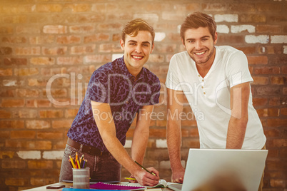 Composite image of smiling creative team working together