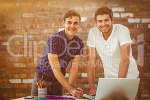 Composite image of smiling creative team working together