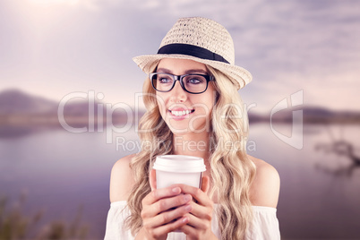 Gorgeous smiling blonde hipster holding take-away cup