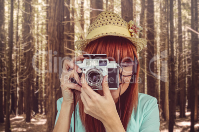 Portrait of a smiling hipster woman holding retro camera Portrait of a smiling hipster woman holding retro camera