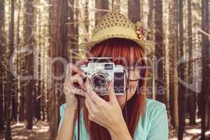 Portrait of a smiling hipster woman holding retro camera